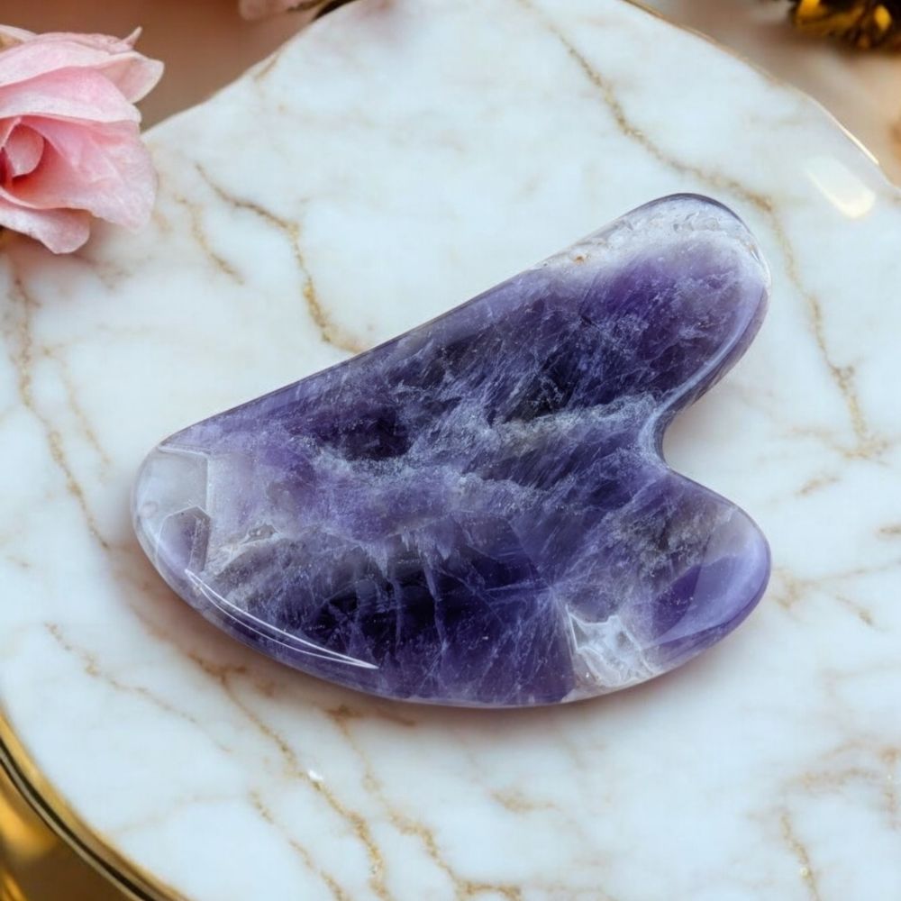 Amethyst facial massage tool with a smooth-edged design, used for skincare, relaxation, and traditional healing.