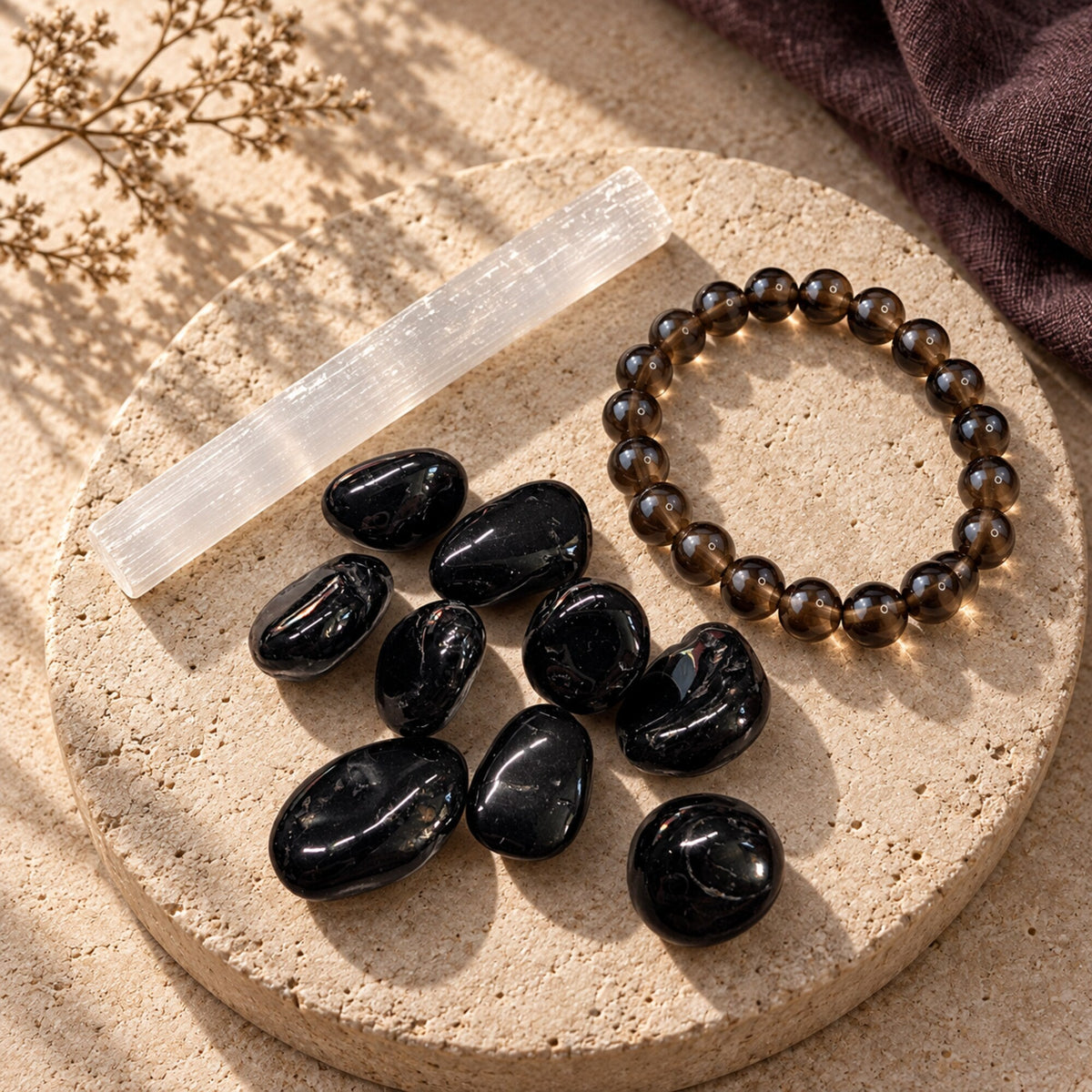 Black Tourmaline, Selenite, and Smoky Quartz styled on warm limestone for Zen Collection’s Protect Your Energy collection.