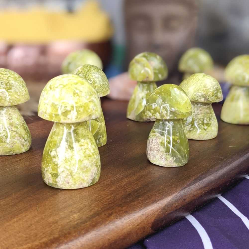 Serpentine crystal with a rich green hue, known for kundalini energy activation, healing properties, and spiritual growth.