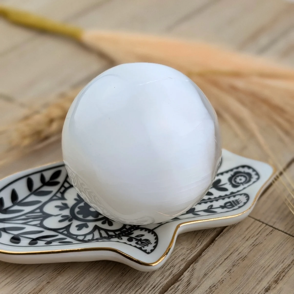 This Selenite Sphere promotes clarity , purity and peace of mind . Use the energy from this crystal sphere to create wholeness throughout the environment and family relationships 