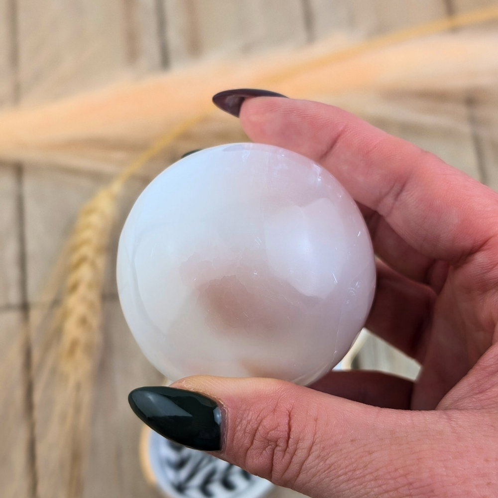 This Selenite Sphere promotes clarity , purity and peace of mind . Use the energy from this crystal sphere to create wholeness throughout the environment and family relationships 