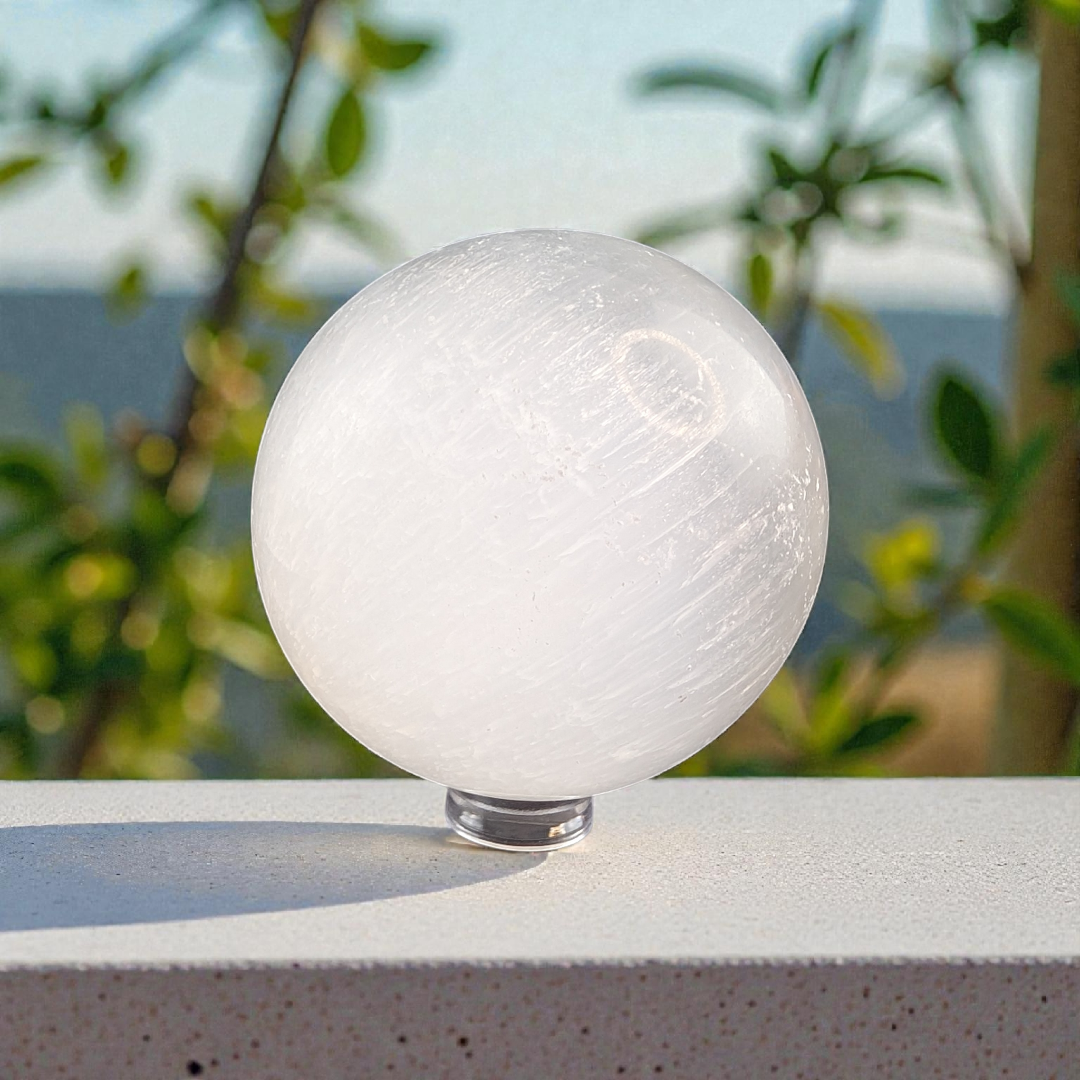 This Selenite Sphere promotes clarity , purity and peace of mind . Use the energy from this crystal sphere to create wholeness throughout the environment and family relationships 