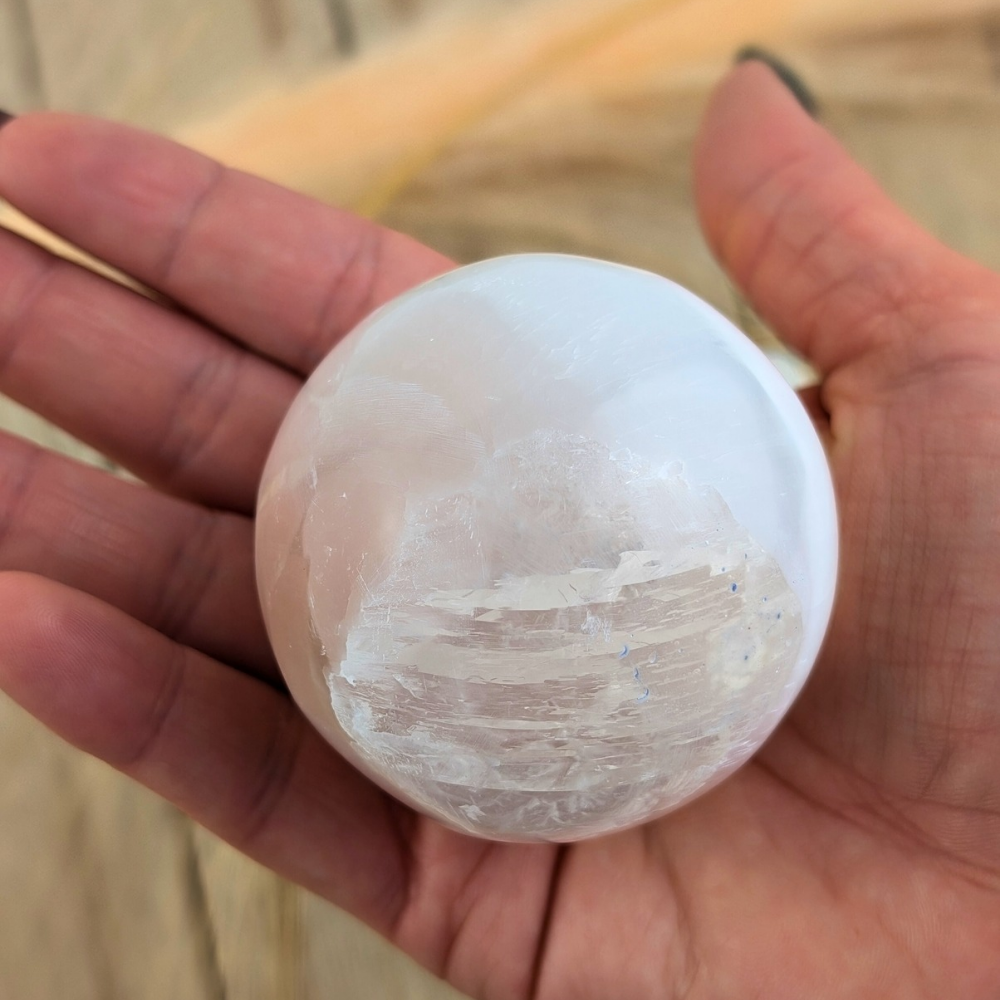 This Selenite Sphere promotes clarity , purity and peace of mind . Use the energy from this crystal sphere to create wholeness throughout the environment and family relationships 