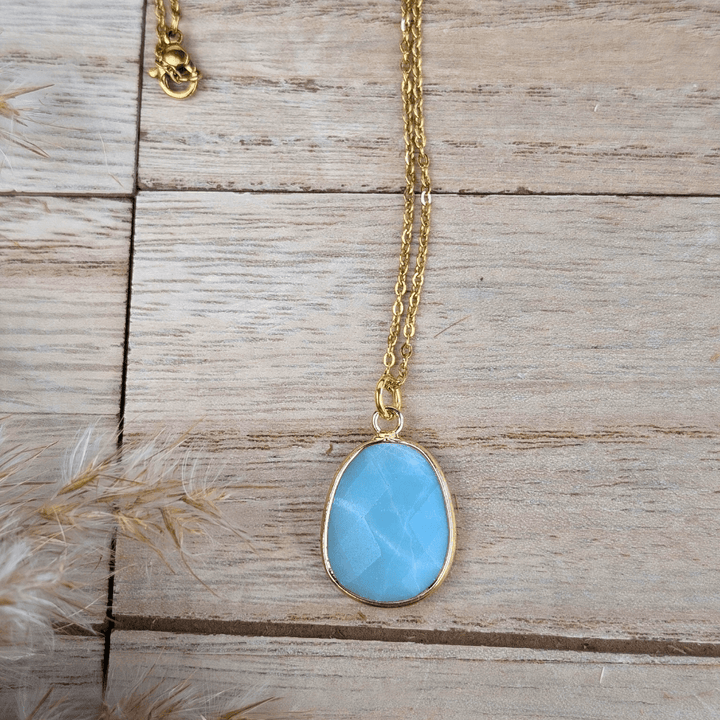 Oval-shaped Amazonite stone set in a gold-tone frame.