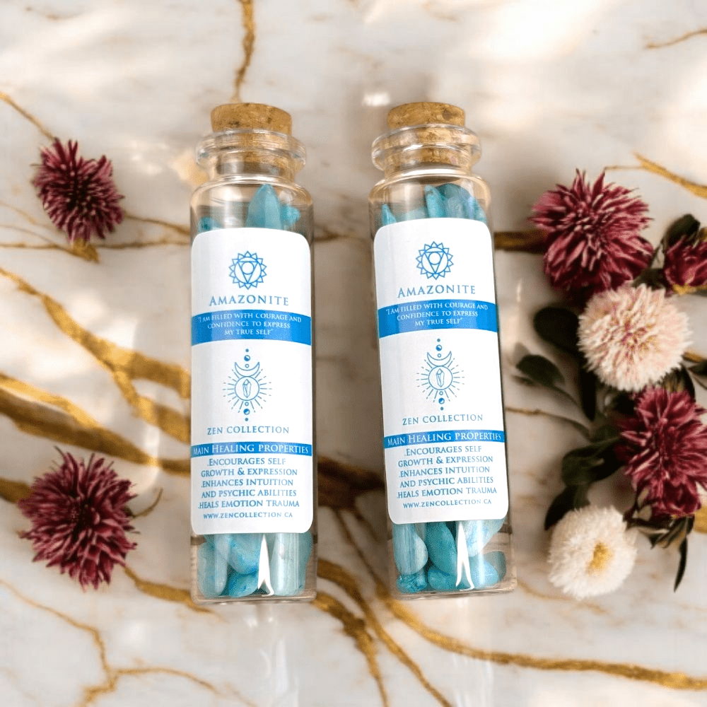Two glass bottles with cork lids containing amazonite crystals on a decorative background with flowers