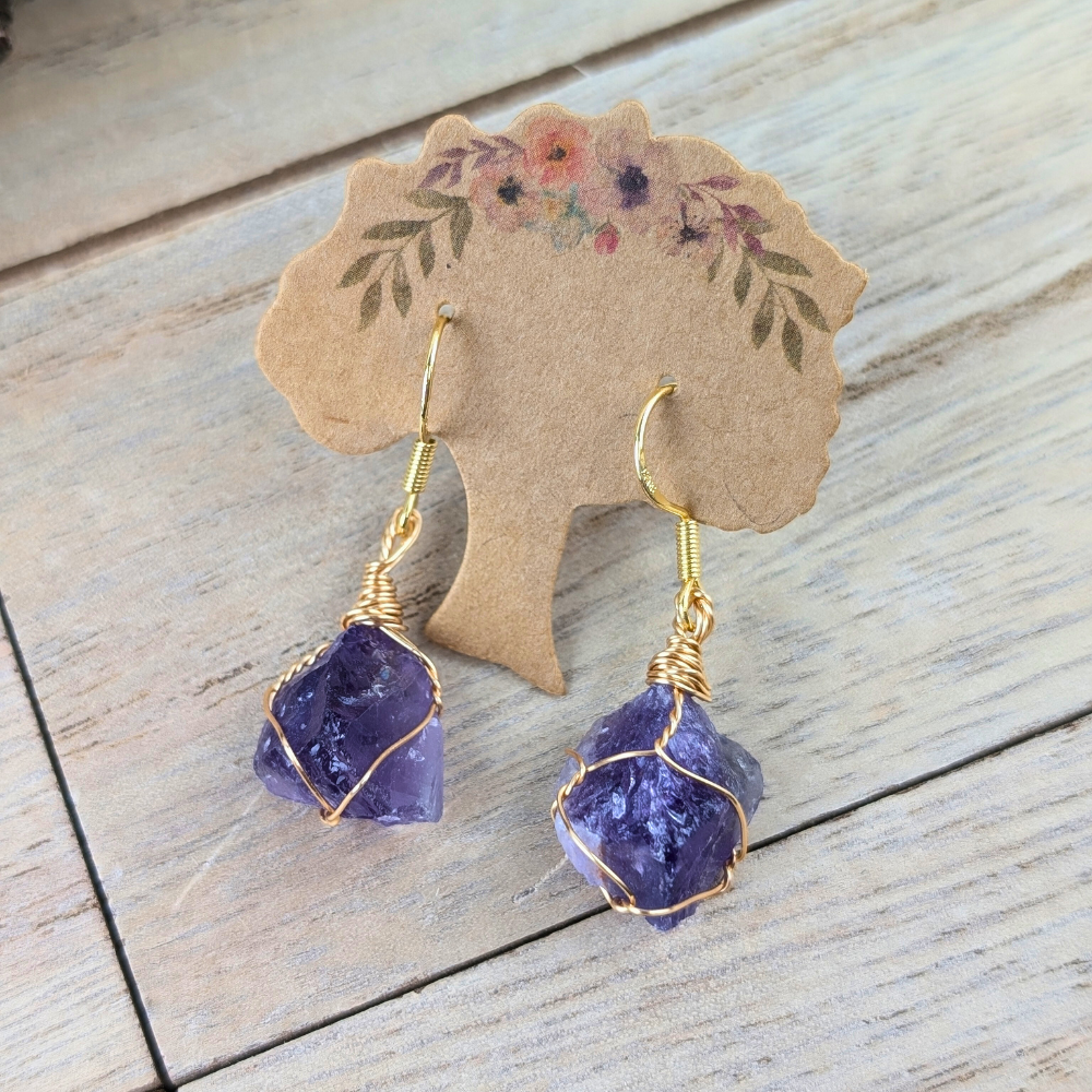 Amethyst jewelry set with delicate wire-wrapped bracelet and graceful earrings.