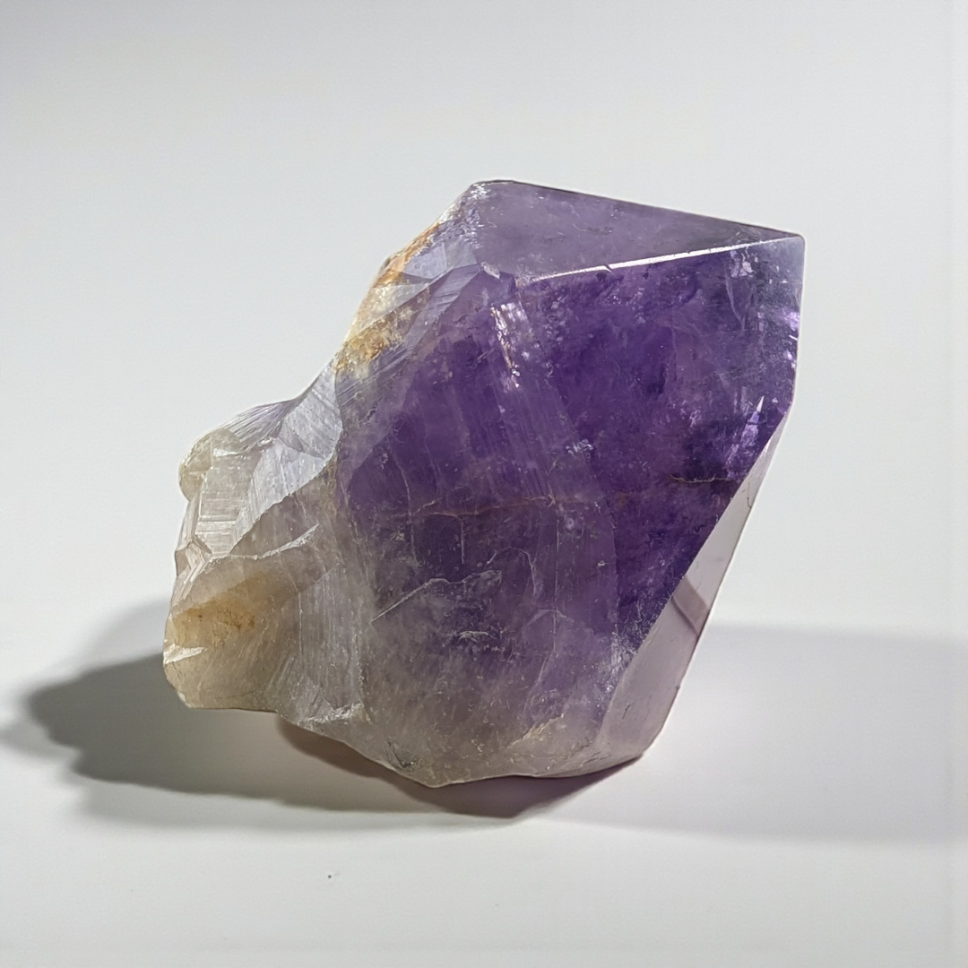 Amethyst Crystal Point with natural inclusions held in hand, photography done by zen collection crystal shop in Barrie