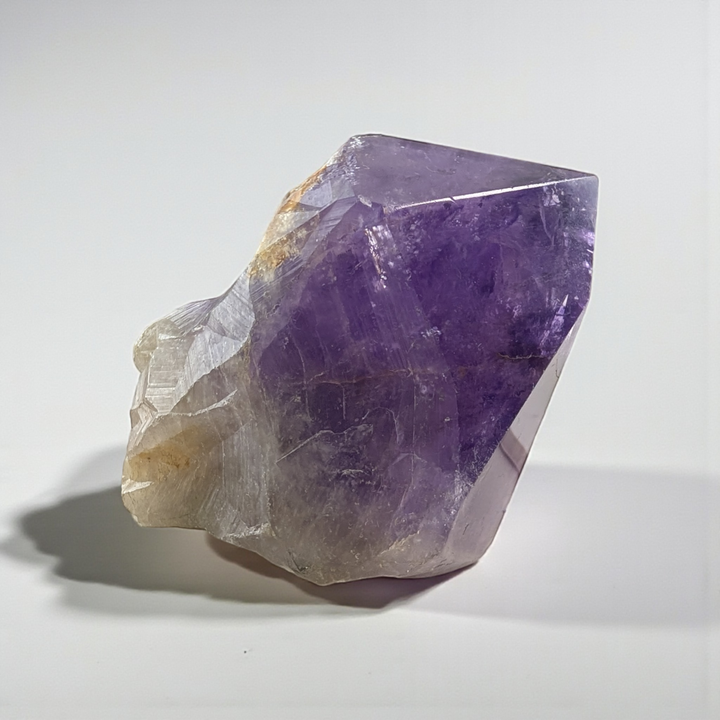 Amethyst Crystal Point with natural inclusions held in hand, photography done by zen collection crystal shop in Barrie