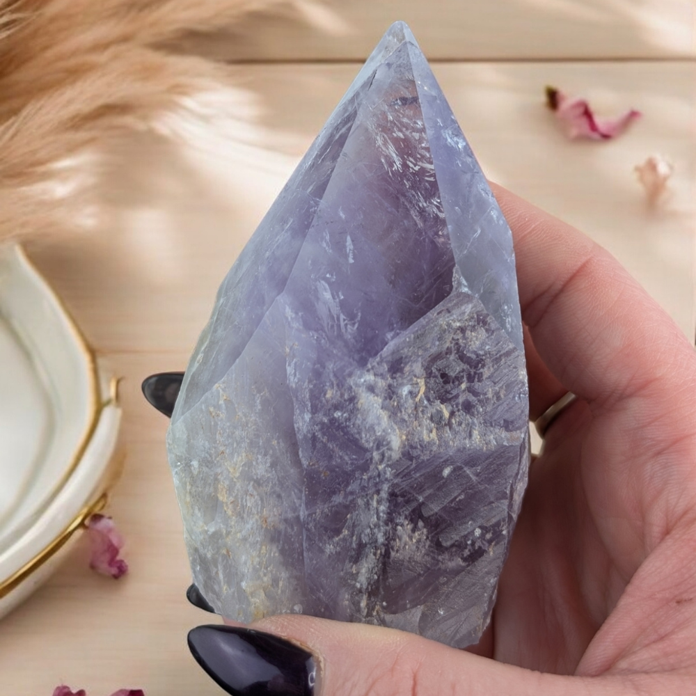 Side view of Amethyst Crystal Point highlighting its polished edges.