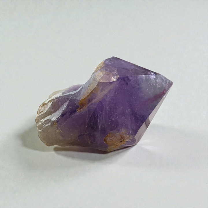 Hand holding Amethyst Crystal Point for meditation and energy work pictures taken by zen collection crystal shops in Barrie ontario