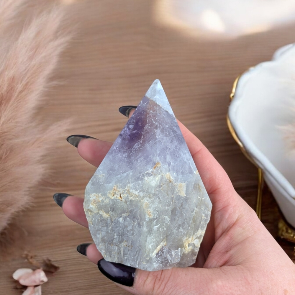 Hand holding Amethyst Crystal Point for meditation and energy work