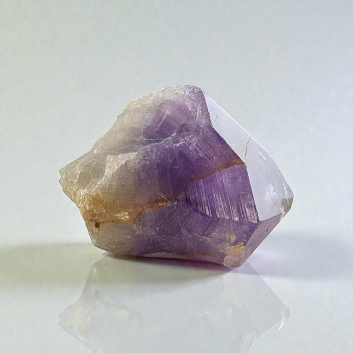 Amethyst Crystal Point displayed on an altar with soft lighting sourced by zen collection new age store in barrie