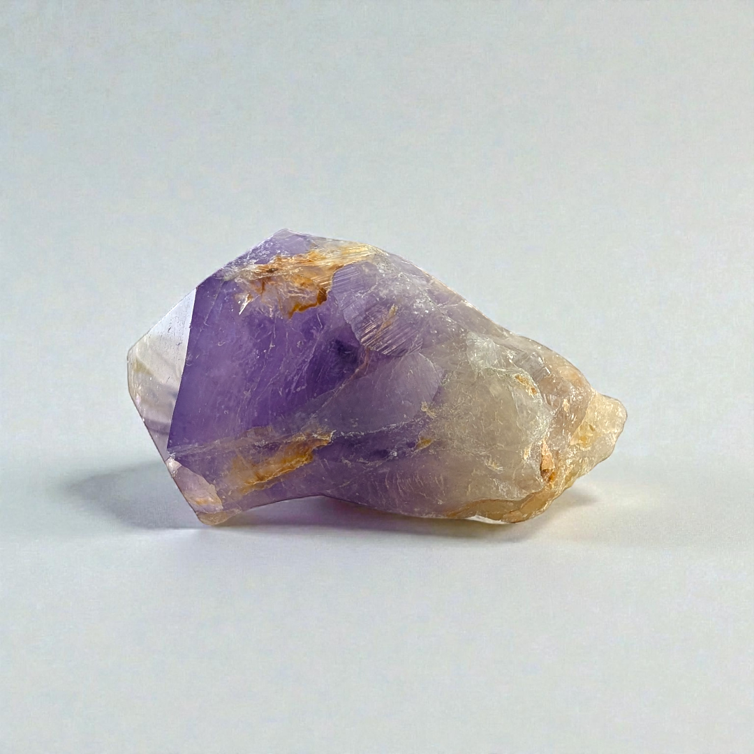 Polished Amethyst Crystal Point against a soft, earthy background picture taken by zen collection crystal store barrie