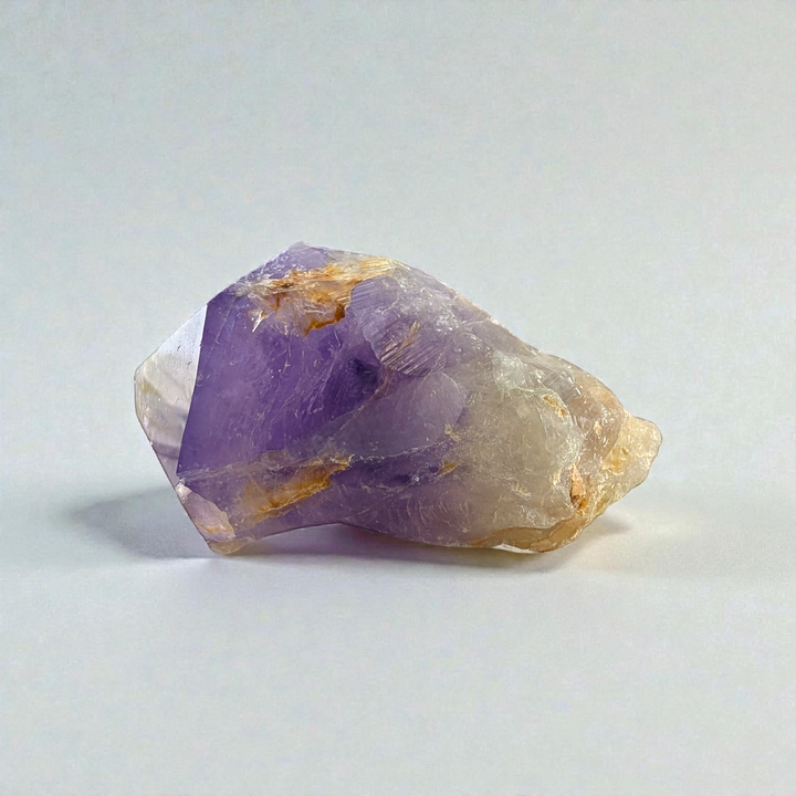 Polished Amethyst Crystal Point against a soft, earthy background picture taken by zen collection crystal store barrie