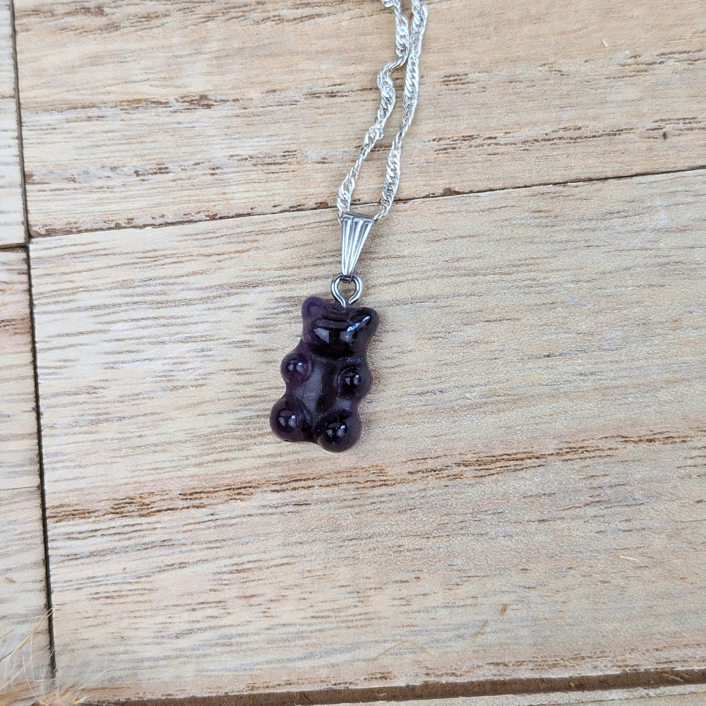 Close-up of faceted amethyst gummy bear pendant