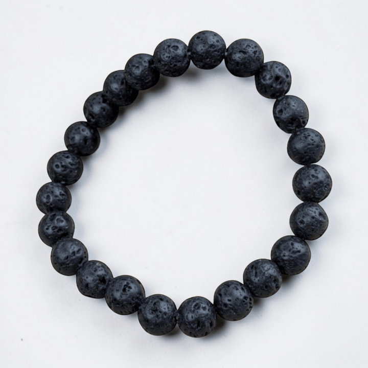 Lava rock bracelet displayed on soft fabric for aesthetic appeal.