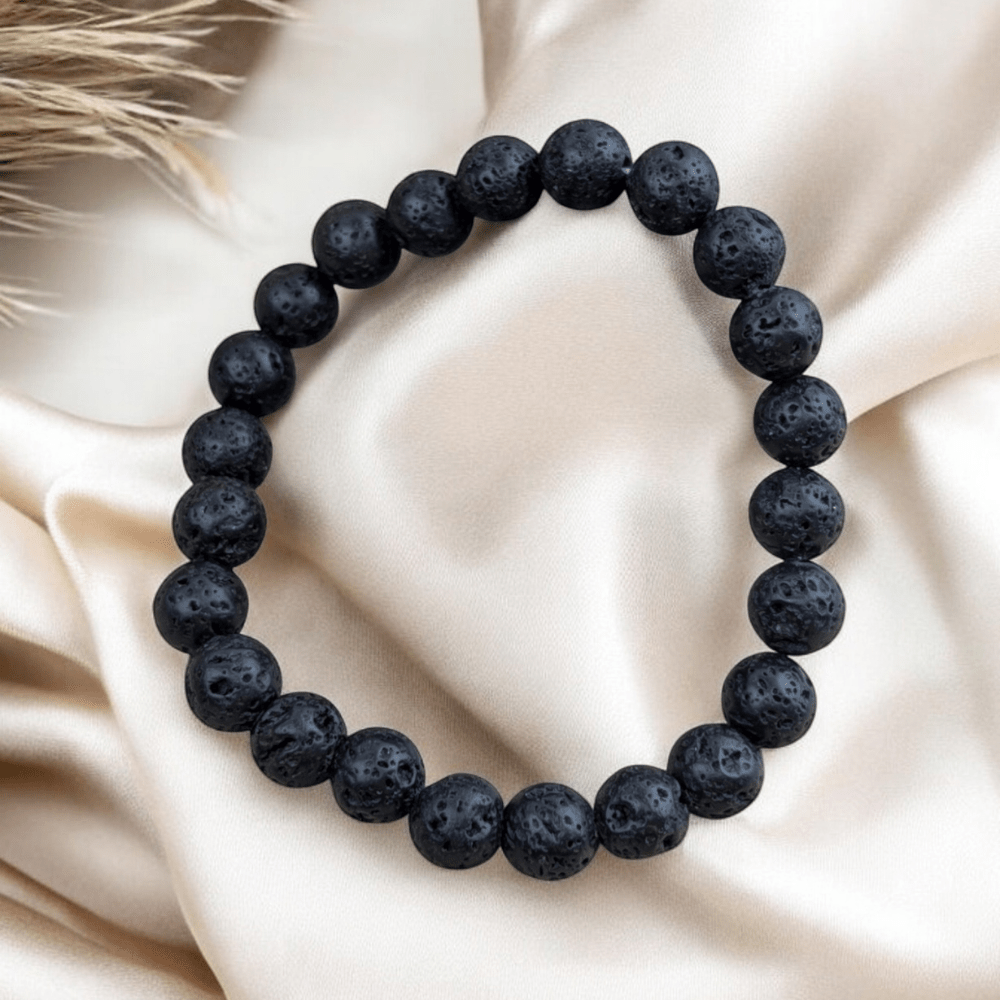 Lava rock bracelet displayed on soft fabric for aesthetic appeal.