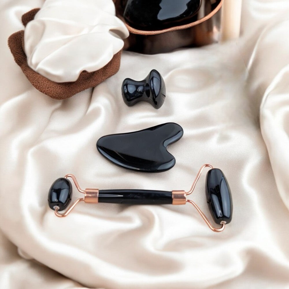 Natural black obsidian tools for facial massage and energy balance.