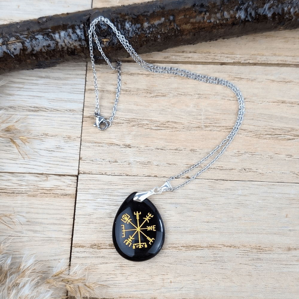 A close-up of the Black Obsidian Viking Rune Necklace, showcasing engraved Viking runes on a smooth obsidian stone.