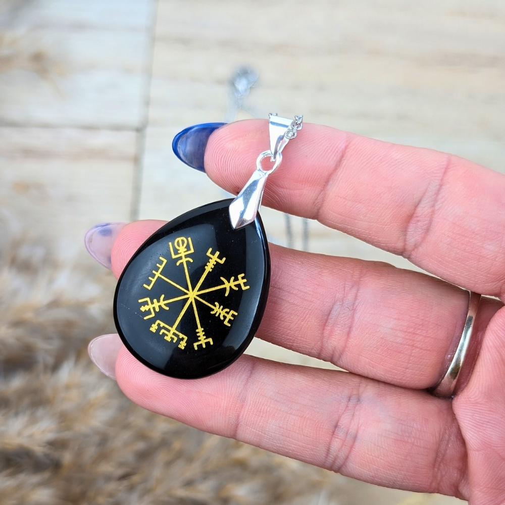 Pendant of the Black Obsidian Viking Rune Necklace – Detailed shot of the Viking rune pendant made from polished black obsidian, highlighting its deep black surface and ancient rune engravings.