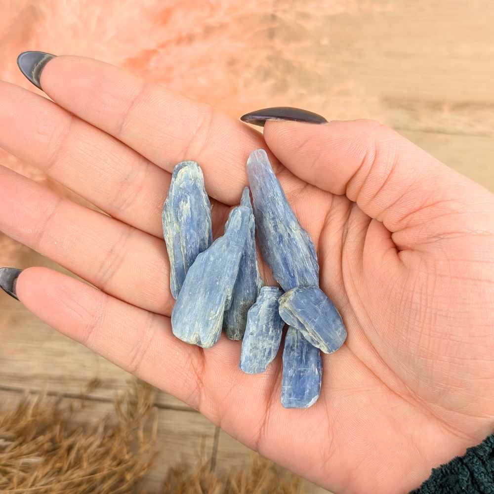 Hand holding Blue Kyanite Blade for chakra alignment