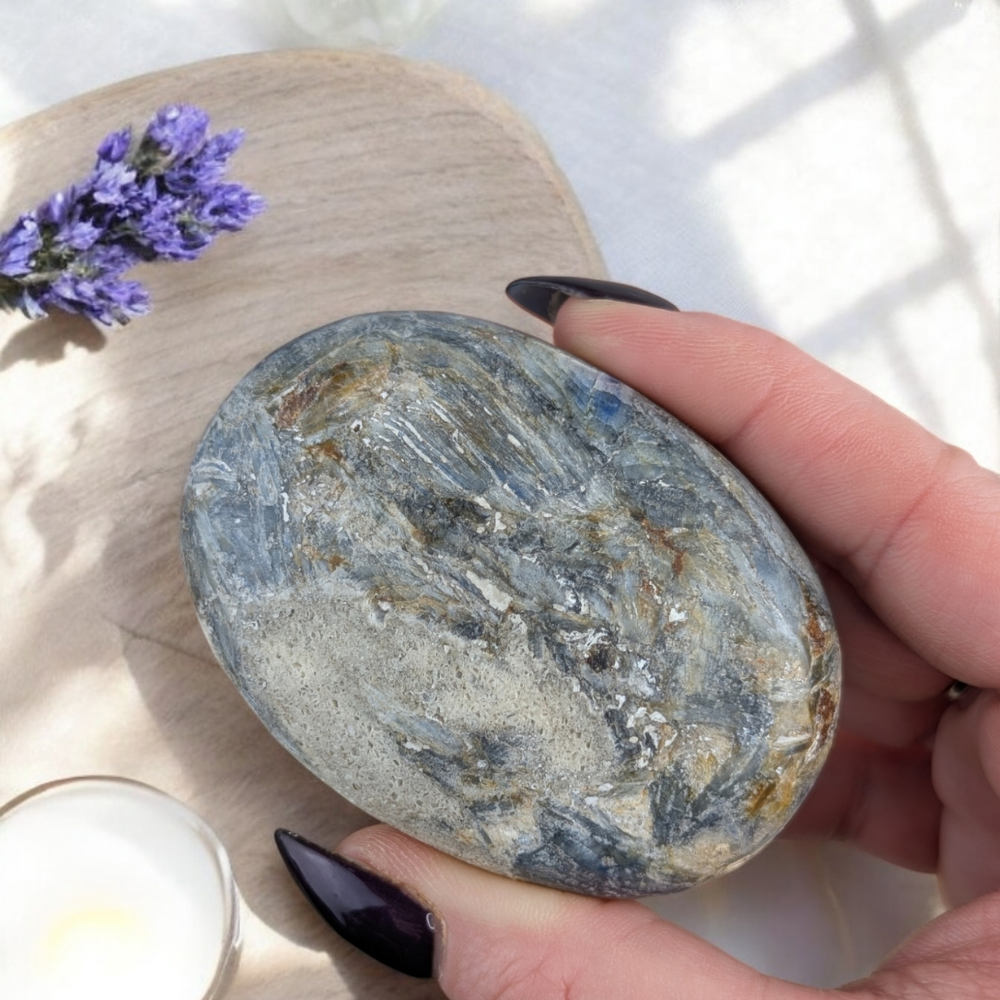 Blue Kyanite Palm Stone paired with other healing crystals.