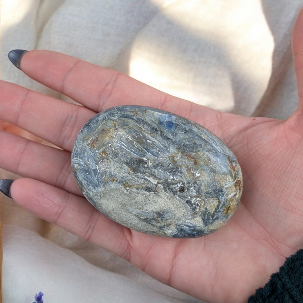 Smooth Blue Kyanite Palm Stone for throat chakra alignment.