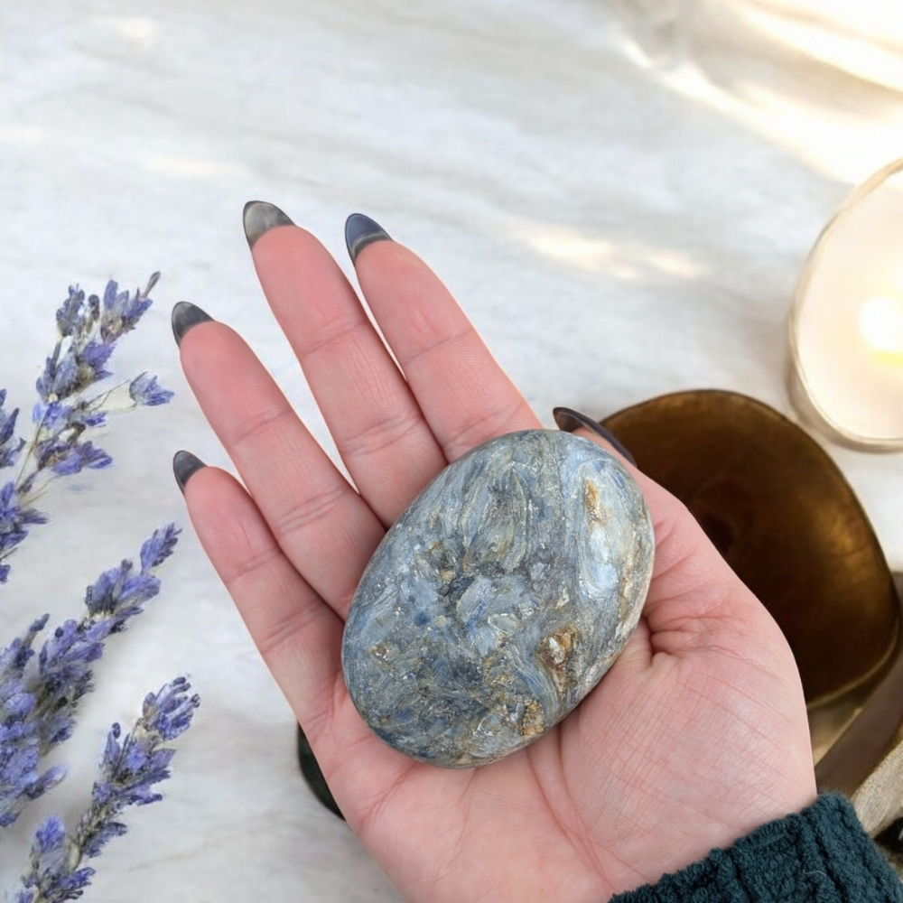 Side view of Blue Kyanite Palm Stone highlighting its natural patterns.