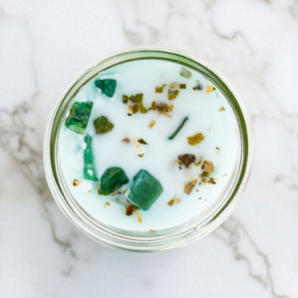 Glass jar with green dessert on a marble surface