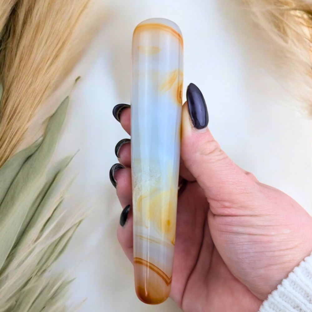 Carnelian Massage Wand featuring natural pale orange and deep orange tones.