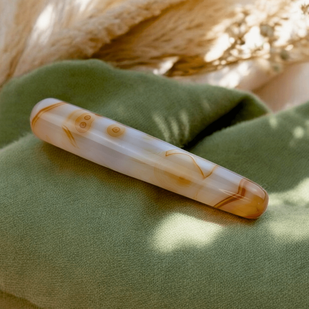 Close-up of carnelian wand showcasing its natural patterns.