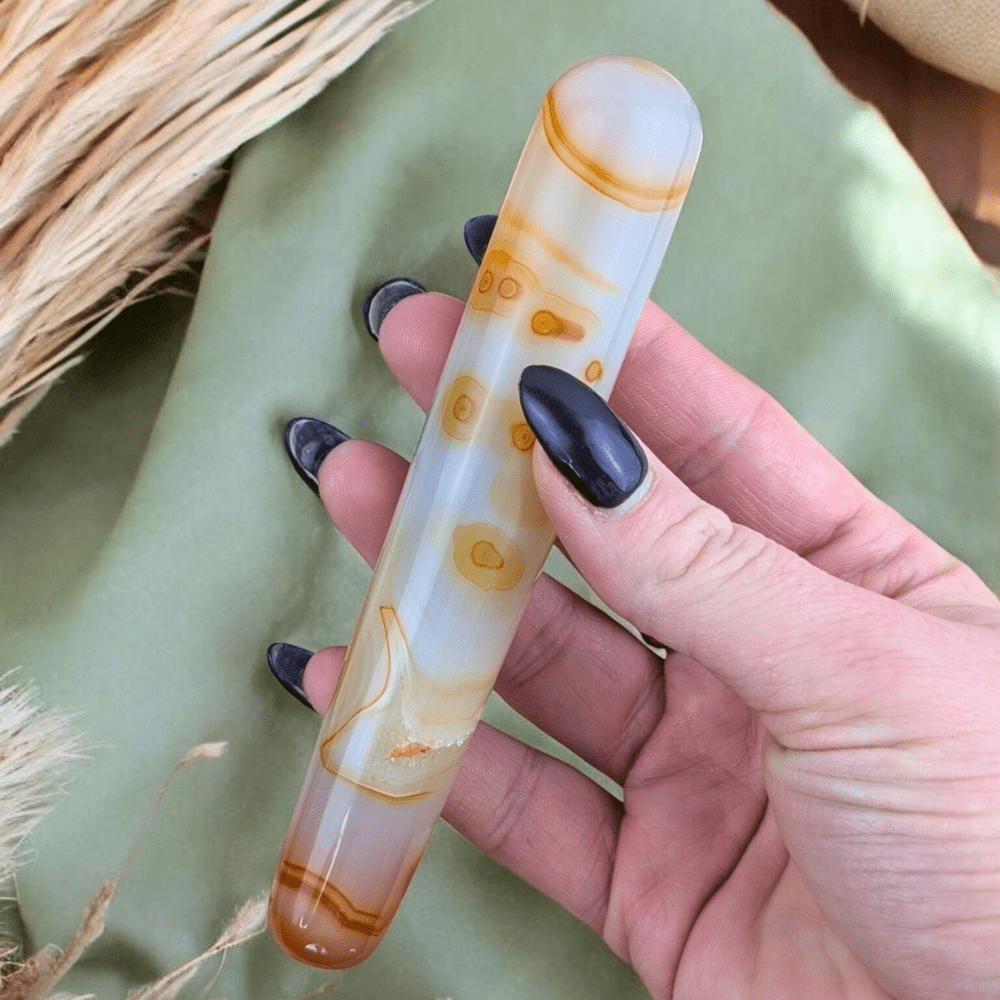 Carnelian wand with pale orange hues and chalcedony texture.