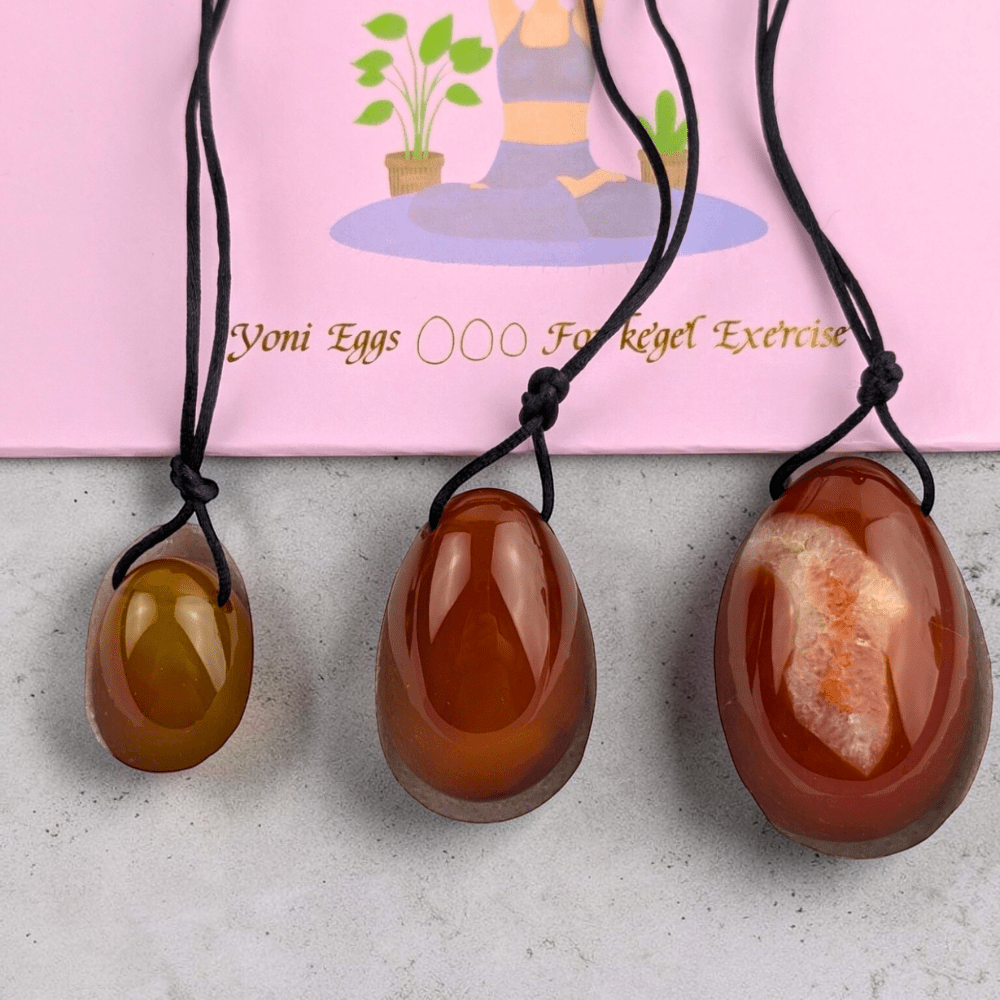 Three sizes of carnelian crystal yoni eggs.