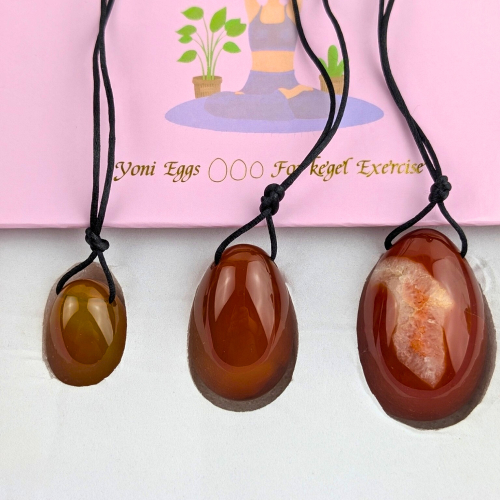 Drilled carnelian yoni eggs with removable string.