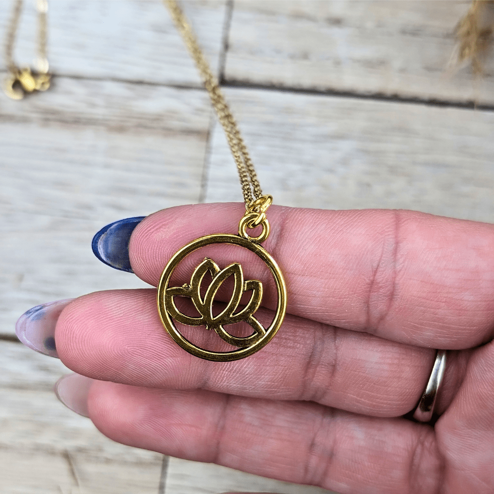 Gold-tone Circle of Hope Pendant Necklace with a lotus flower design.