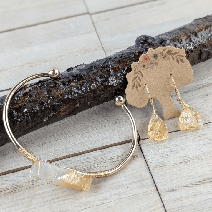 Citrine wire-wrapped bracelet on wood background.