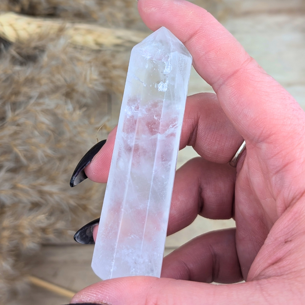 Clear Quartz crystal lying flat, showcasing its unique facets.