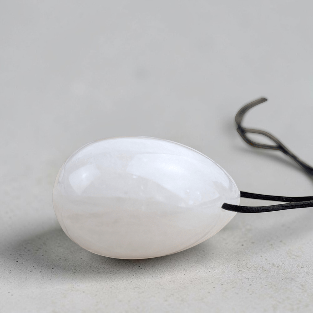 Polished clear quartz yoni egg set for spiritual healing.