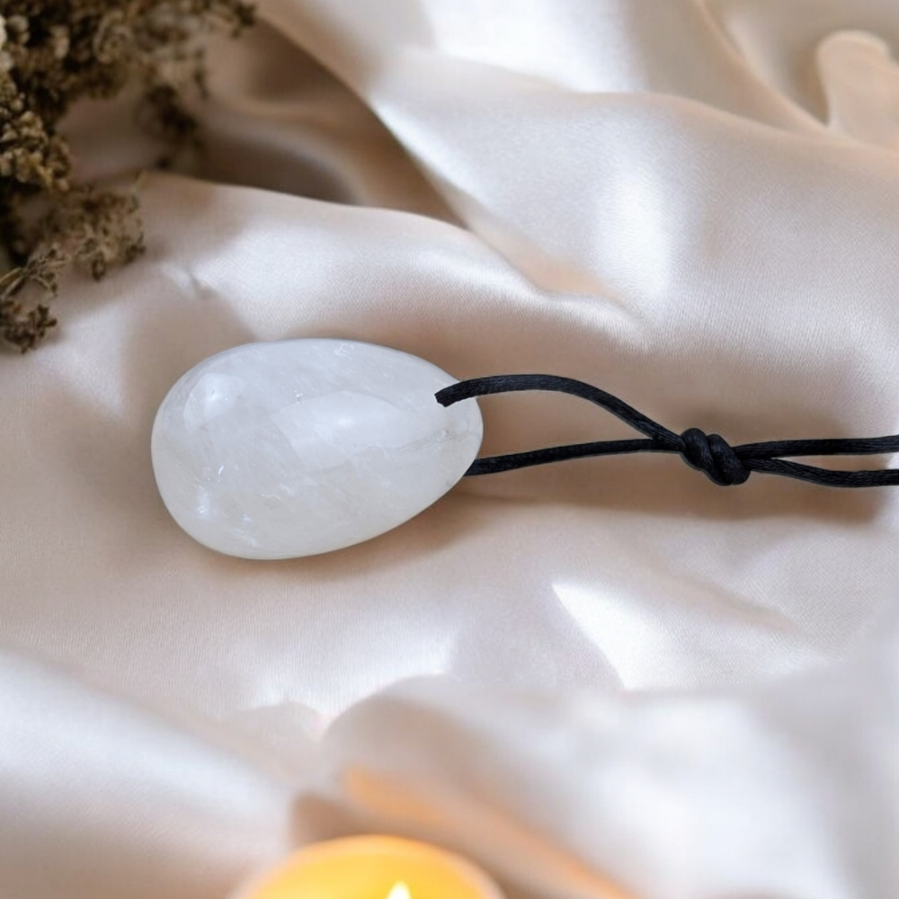 Polished clear quartz yoni egg set for spiritual healing.