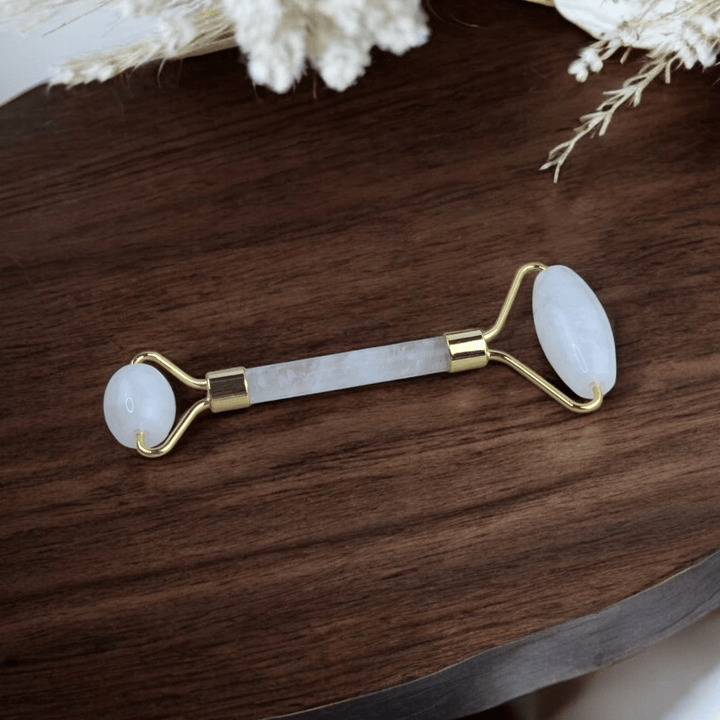 Dual-ended crystal roller for facial massage and skincare.