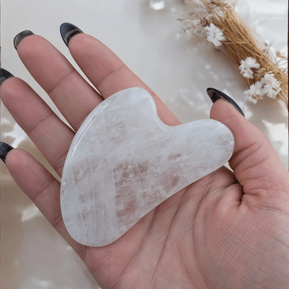 Natural clear quartz gua sha for lymphatic drainage.