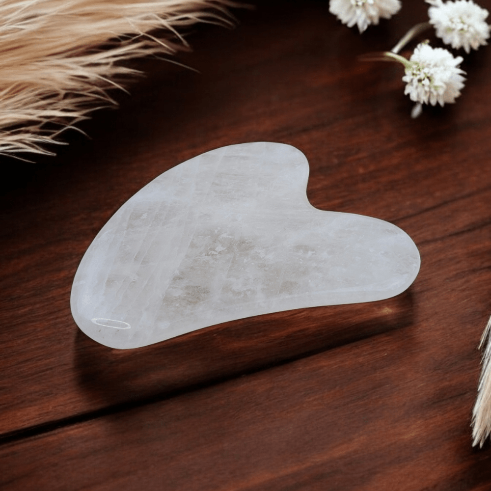 Polished clear quartz gua sha for facial massage.