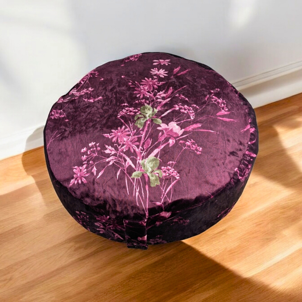 Round crushed velvet cushion on a white rug