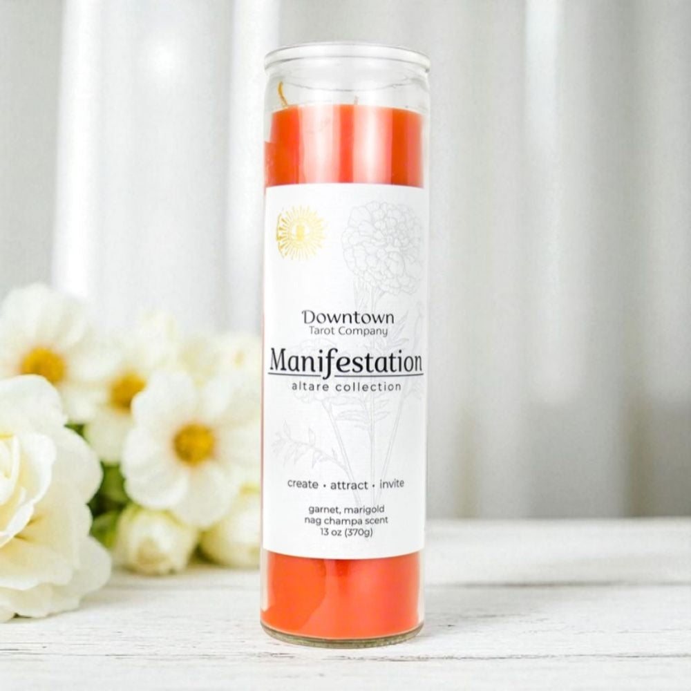 Manifestation candle with white flowers in the background