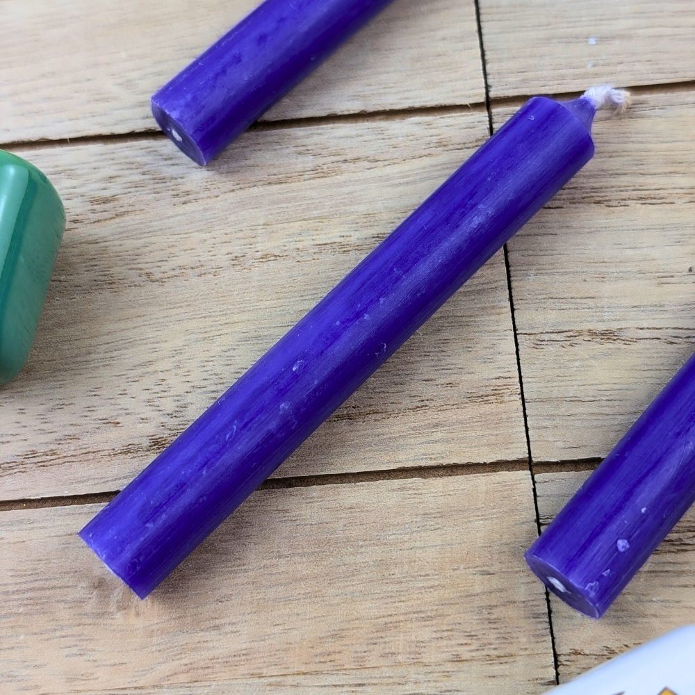 Violet candle with candle holders for spiritual practice
