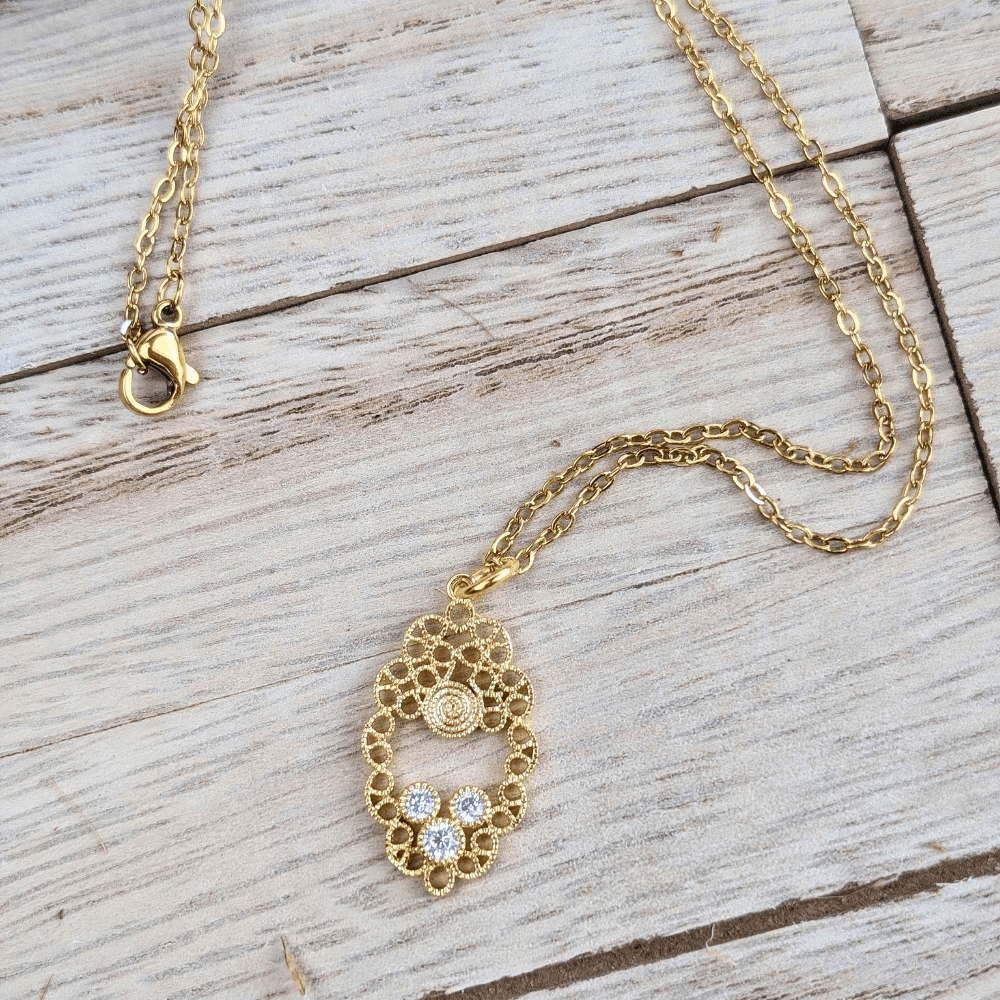 Brass mandala-inspired pendant with cubic zirconia, spiritual jewelry for unity and clarity.