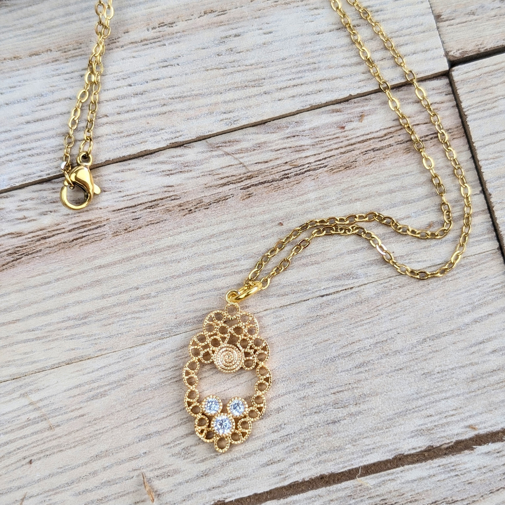 Brass mandala-inspired pendant with cubic zirconia, spiritual jewelry for unity and clarity.