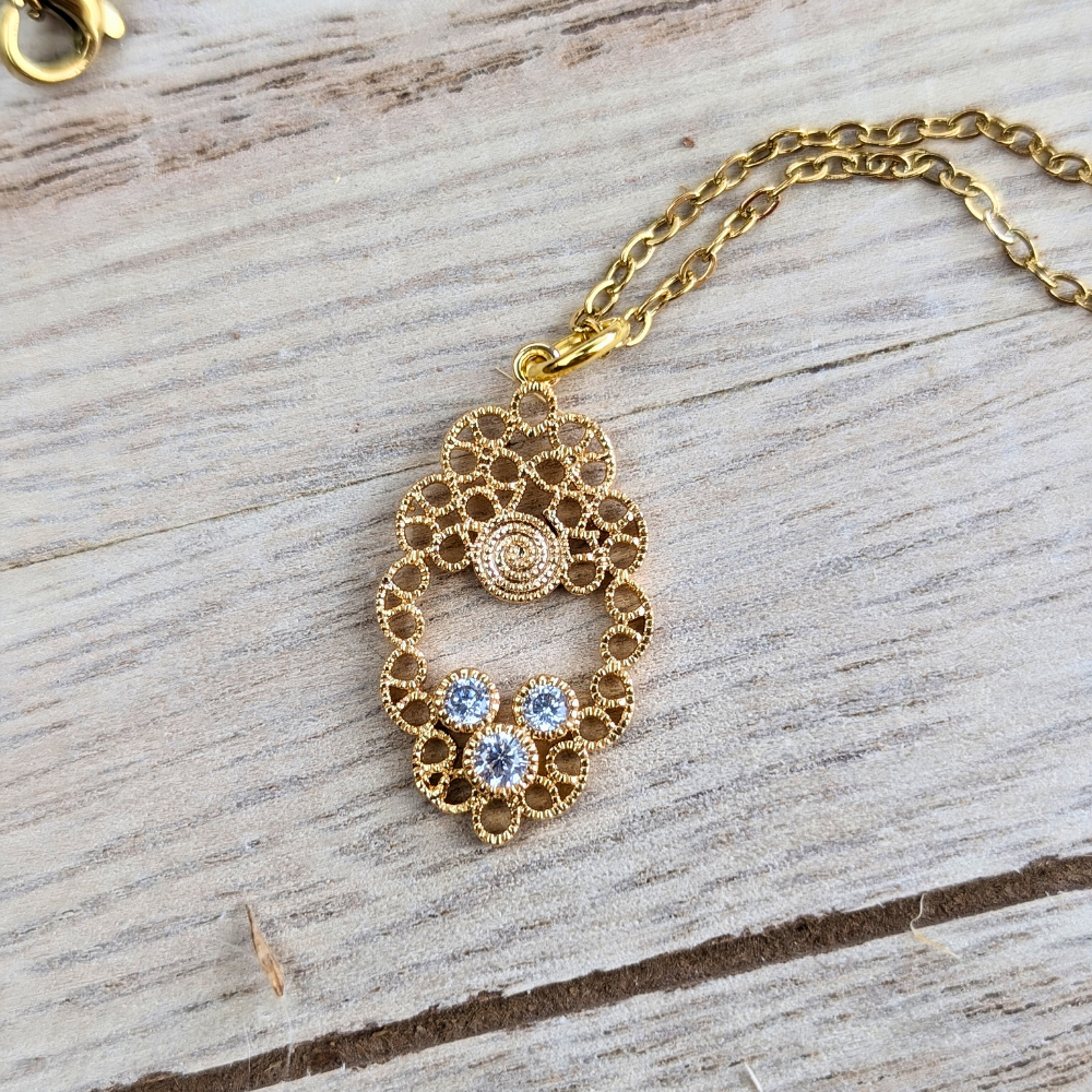 Mandala necklace in brass with cubic zirconia, representing spiritual balance and oneness