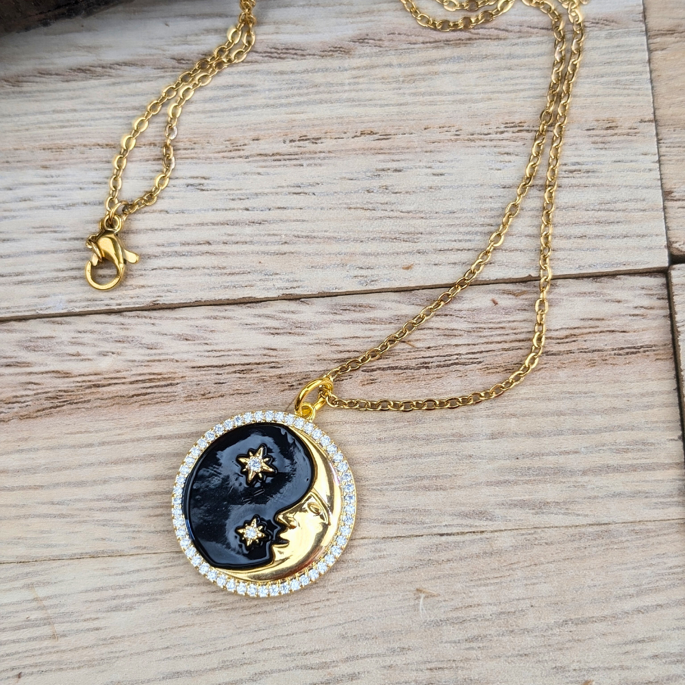 Eternal Cosmos Necklace with brass crescent moon and stars, black enamel, and cubic zirconia