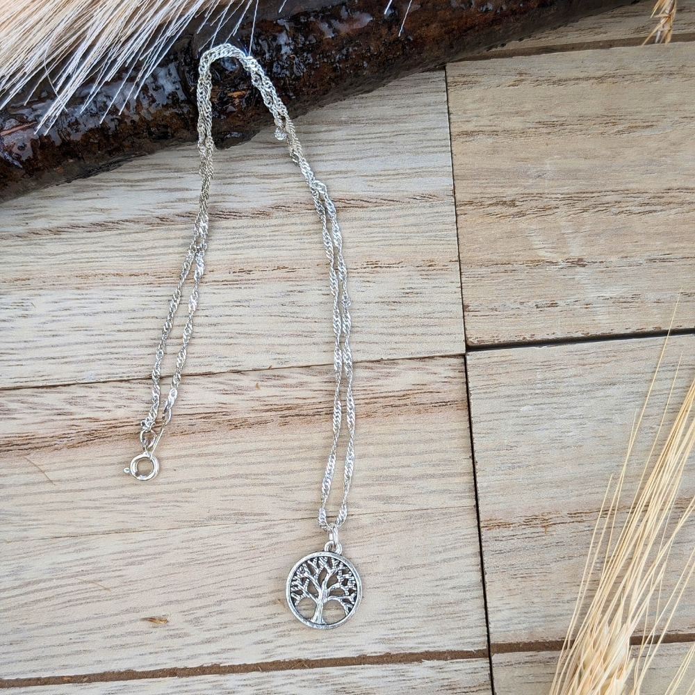 Eternal Growth Necklace featuring a tree of life design encased in a golden circle.